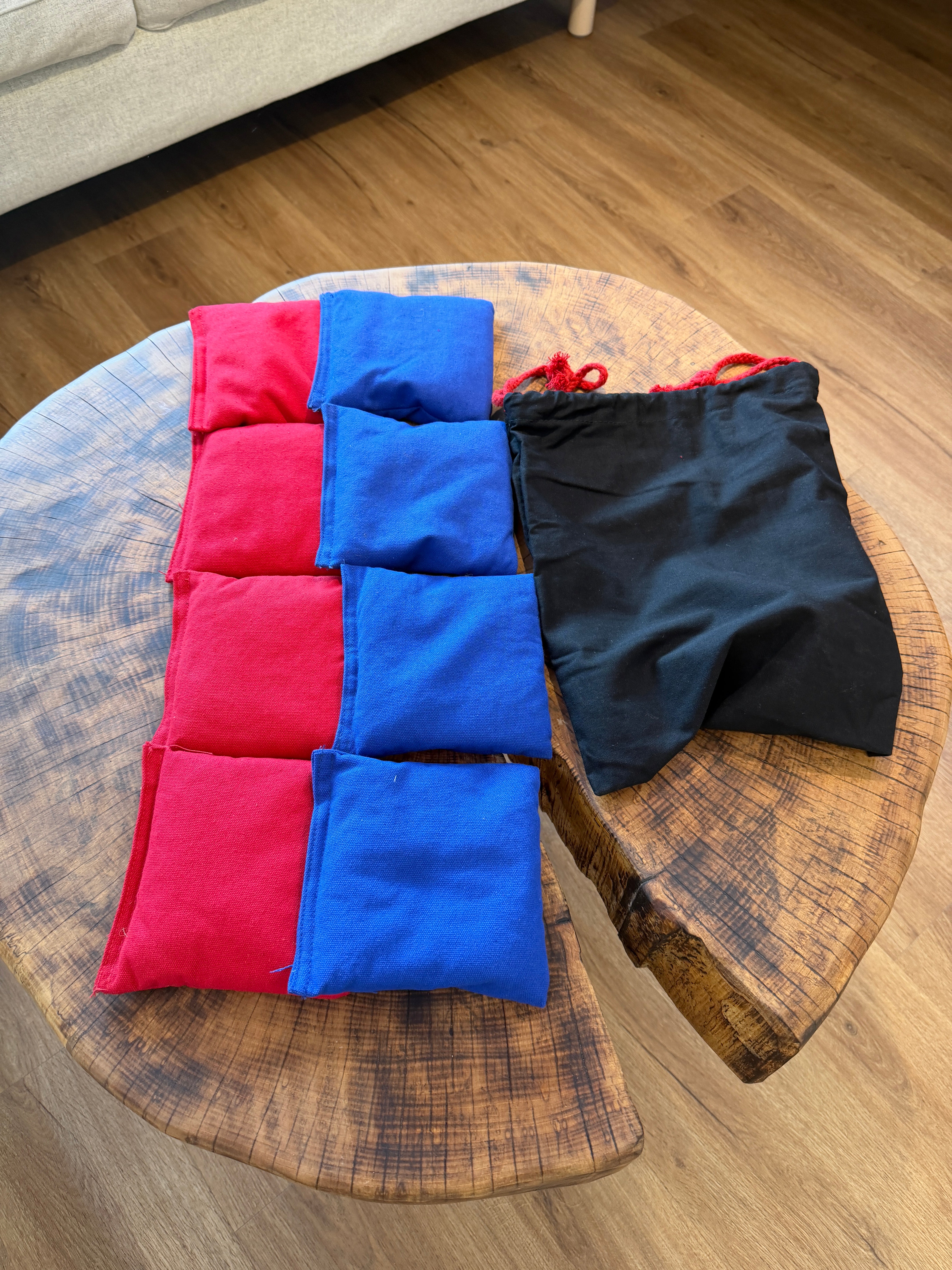 Bean Bags rot und blau auf Holztisch · astkern Cornhole Gartenspiel